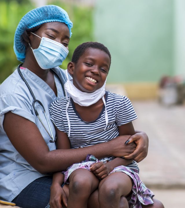 A closeup shot of a boy and a doctor wearing sanitary masks